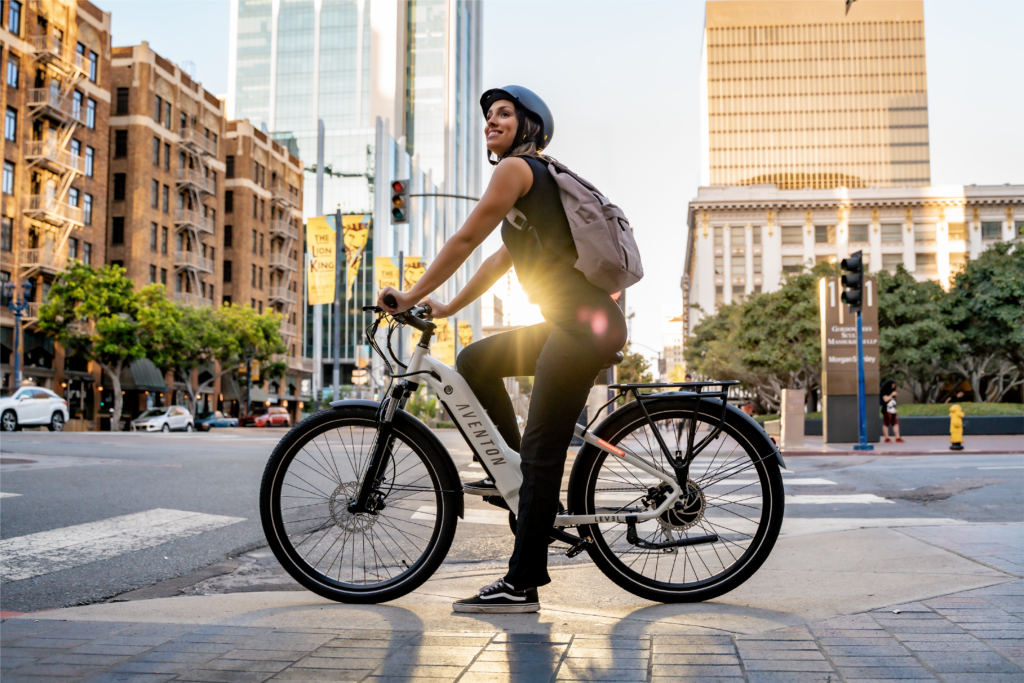 Stylish Aventon Level.2 eBike with sleek frame design, showcasing its fully-integrated 48V 14Ah battery, hydraulic disc brakes, and Shimano 8-speed gear system. Positioned against an urban backdrop, ready for commuting or leisure riding
