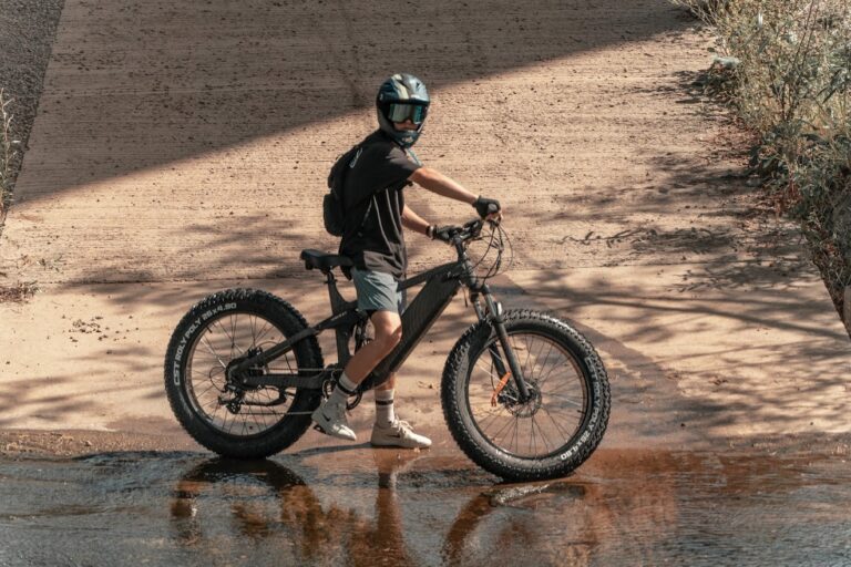 The Himiway Cobra eBike on a rugged trail, highlighting its 750W geared hub motor, 26*4.8 Super Fat Tires, and Shimano 7-speed gear shift system, ready for adventure.