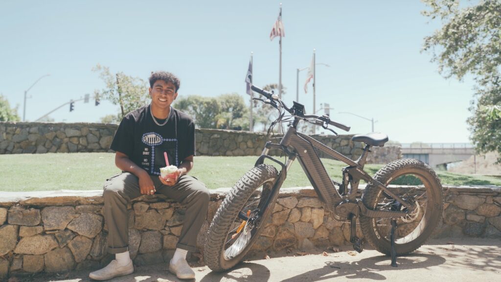 The Himiway Cobra eBike on a rugged trail, highlighting its 750W geared hub motor, 26*4.8 Super Fat Tires, and Shimano 7-speed gear shift system, ready for adventure.
