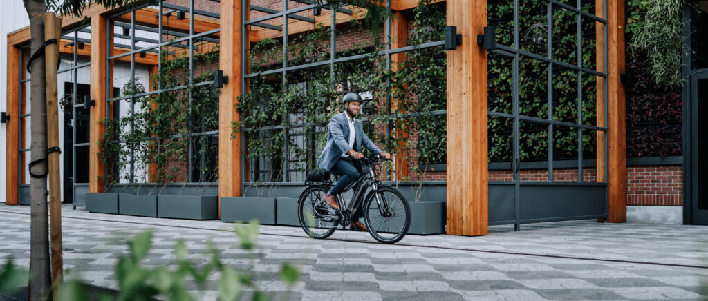 Stylish Aventon Level.2 eBike with sleek frame design, showcasing its fully-integrated 48V 14Ah battery, hydraulic disc brakes, and Shimano 8-speed gear system. Positioned against an urban backdrop, ready for commuting or leisure riding.