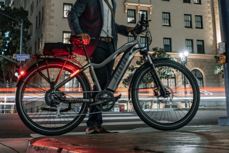 Stylish Aventon Level.2 eBike with sleek frame design, showcasing its fully-integrated 48V 14Ah battery, hydraulic disc brakes, and Shimano 8-speed gear system. Positioned against an urban backdrop, ready for commuting or leisure riding