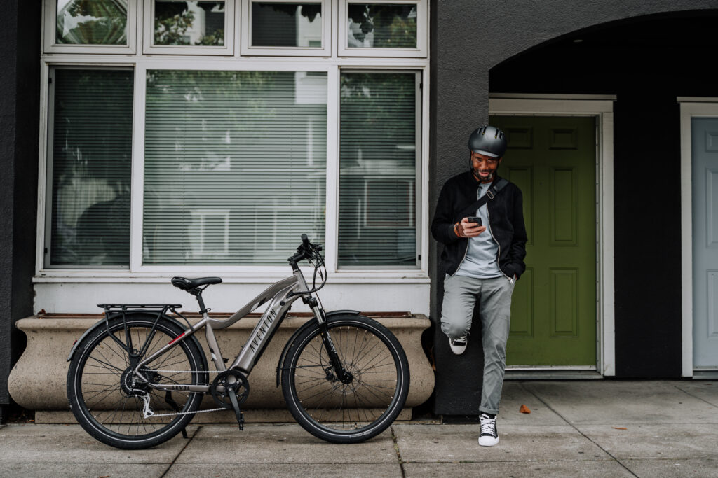 Stylish Aventon Level.2 eBike with sleek frame design, showcasing its fully-integrated 48V 14Ah battery, hydraulic disc brakes, and Shimano 8-speed gear system. Positioned against an urban backdrop, ready for commuting or leisure riding