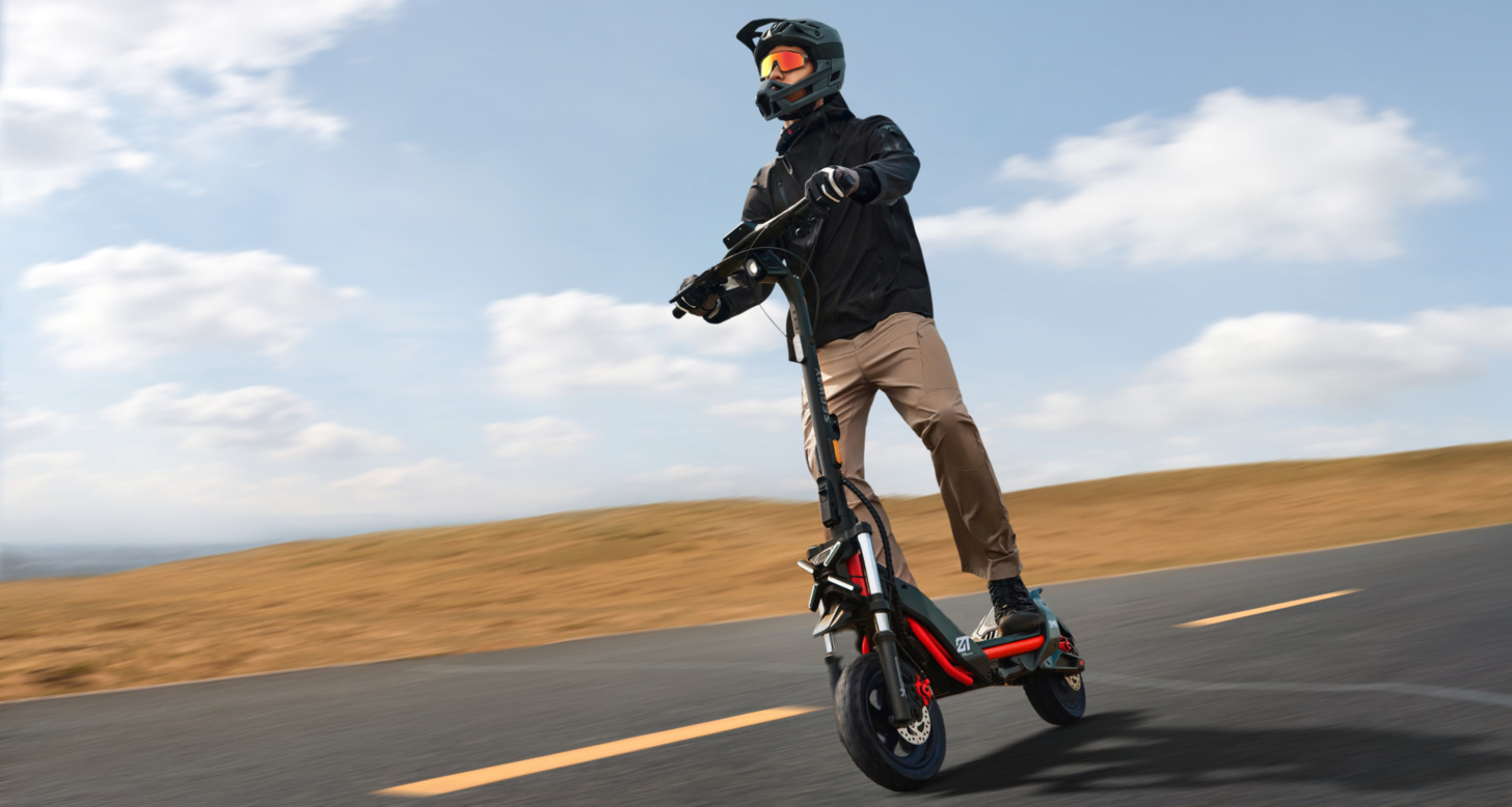 Segway ZT3 Pro eKickScooter cruising along Tampa Bay waterfront with city skyline in background