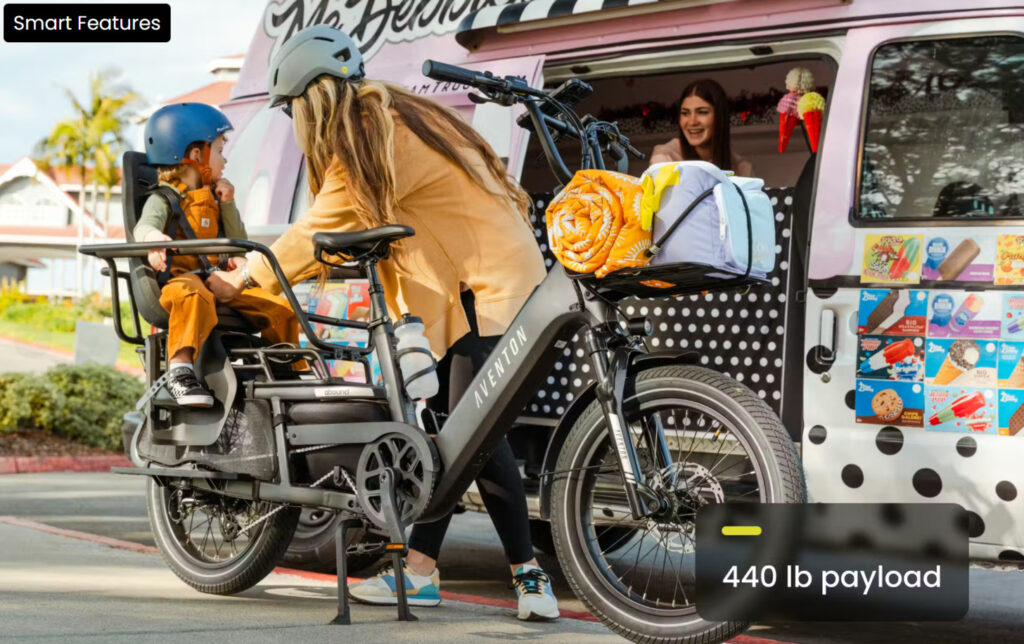 eCargo bike with storage compartments and passenger seating being used for grocery shopping