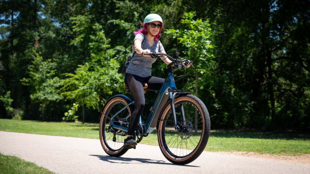 Helmeted rider on a Metallic Blue AIMA Santa Monica step-through ebike