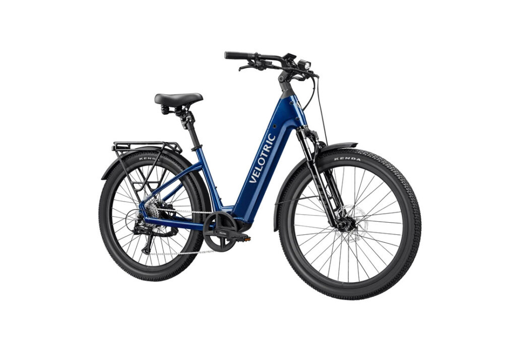 Velotric Discover 3 in Lemans Blue, front three-quarter view showing air suspension fork and step-through frame