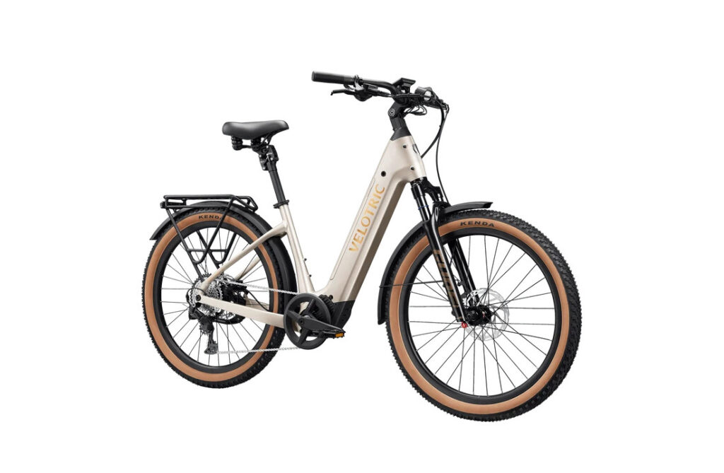 Velotric Discover M in Platinum Silver, front three-quarter view showing air suspension fork and tan-wall tires