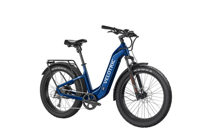 Velotric Nomad 2 in Midnight Blue, front three-quarter view showing the fork and fat tire Velotric Nomad 2 in Midnight Blue, front three-quarter view showing the fork and fat tire