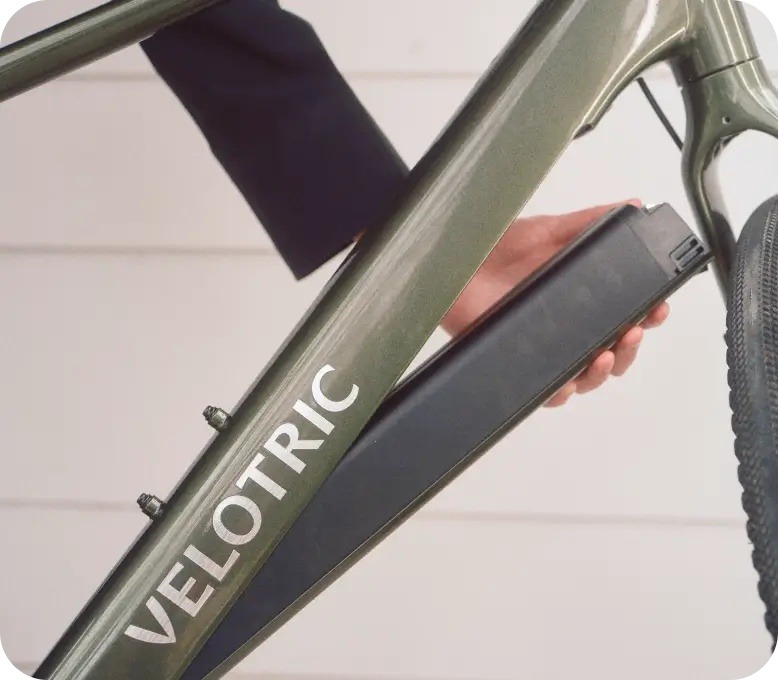 Velotric Tempo removable battery being lifted from the downtube Velotric Tempo removable battery being lifted from the downtube